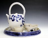Pottery porcelain and ceramic tea set with five unique tea bowls.