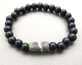 Mens black acrylic pearl beaded stretch bracelet with green rectangle eye bead