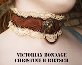 Upcycled Bondage Collar of leather, vintage lace, vintage brass drawer pull, and antique bone.  Hand sewn.
