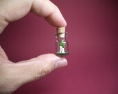Playing harp in front of the tree in a tiny bottle