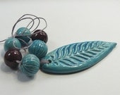 Handmade stamped long feather ceramic pendant and bead set