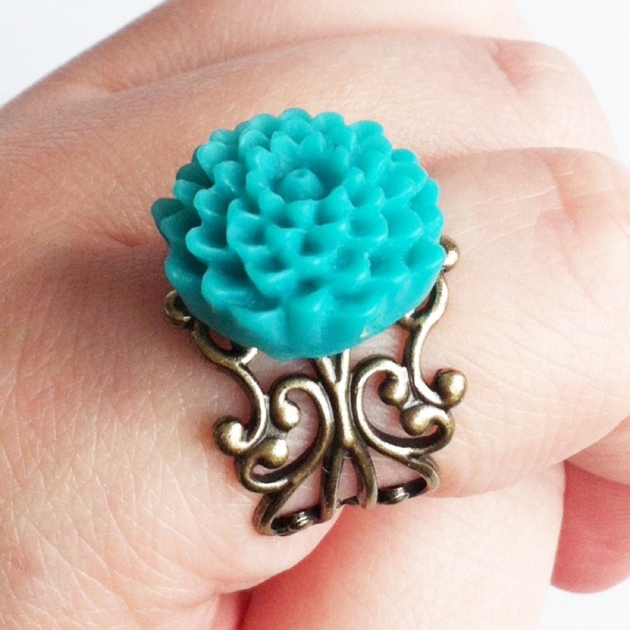 Something Blue Bridal Ring with teal blue pom flower on a gold band in ivory organza gift bag for bride on wedding day gift