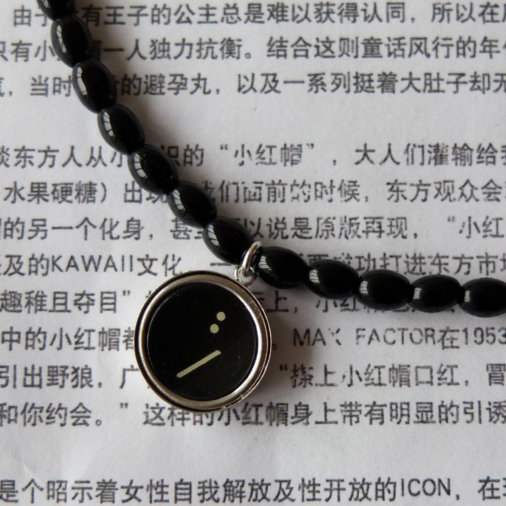 Typewriter key pendant :/  in a sterling silver setting with onyx semi-precious beads