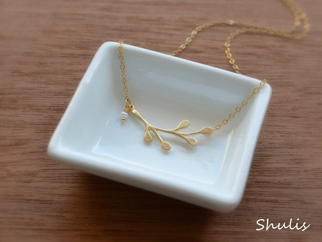 Delicate young necklace with a beautiful branch pendant and a tiny white fresh water pearl. Branch is 16k matte gold plated brass attached to a 14k gold filled necklace. 