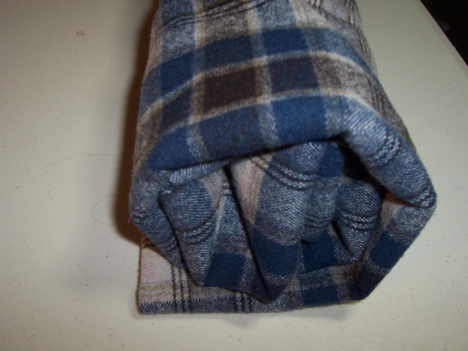 Plaid felted Pendleton shirt weight wool fabric in blues, greys and black.