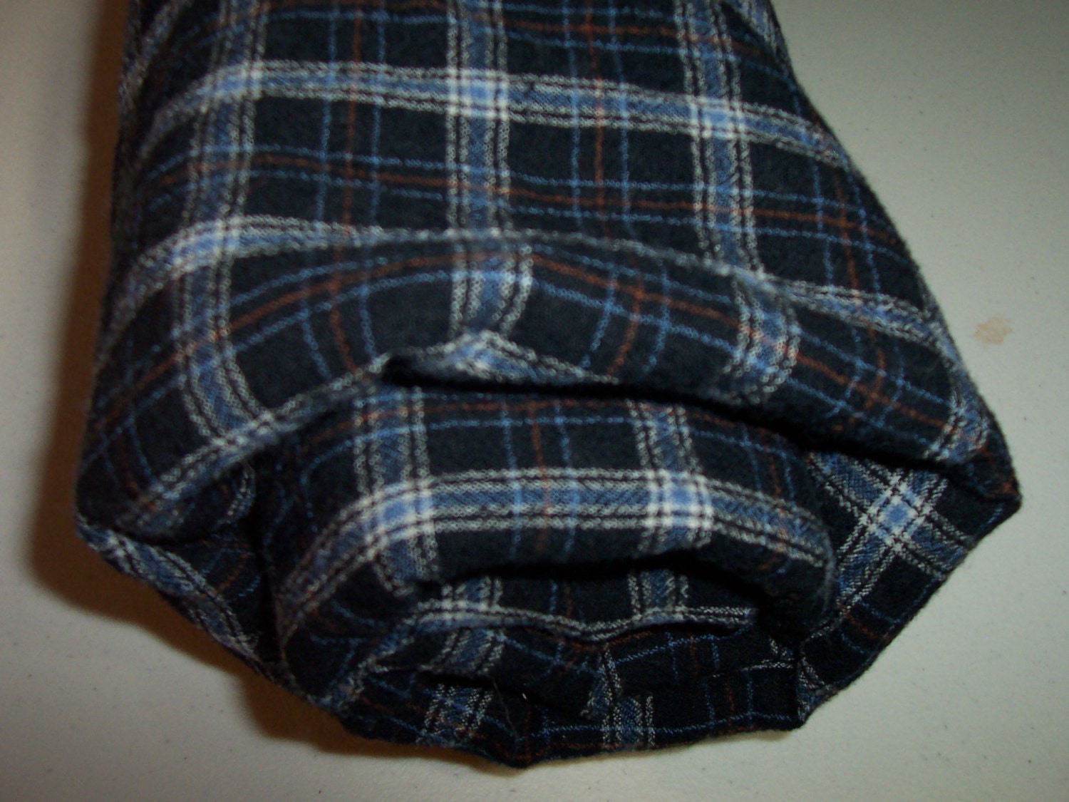 Plaid felted Pendleton shirt weight wool fabric in blues, brown , grey and black.