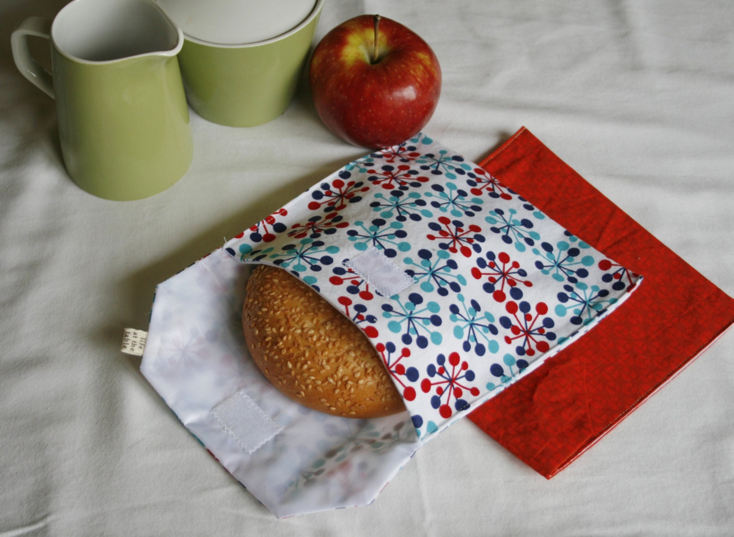 pair of reusable, lined sandwich bags in blue and red bursts