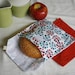 pair of reusable, lined sandwich bags in blue and red bursts