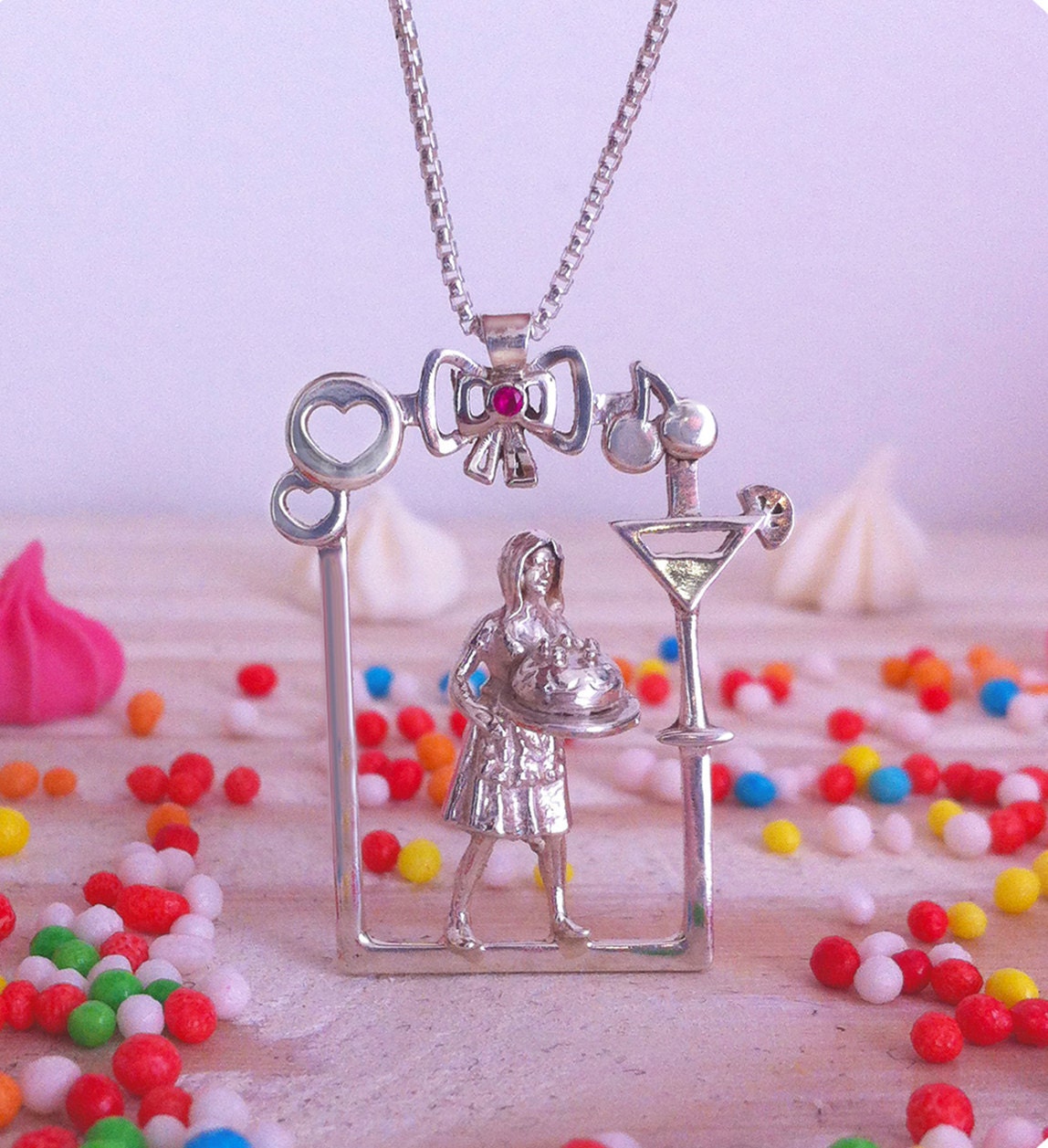 Silver pendant of a lovely woman holding a wonderful Cake with whipped cream and Cherries