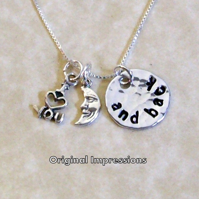 I love you to the moon and back pendant necklace of aluminum with tiny sterling silver charms on a sterling silver chain.