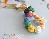 Teething toy rattle with crochet wooden beads and 3 wooden rings. Yellow, white, blue, green, lila.