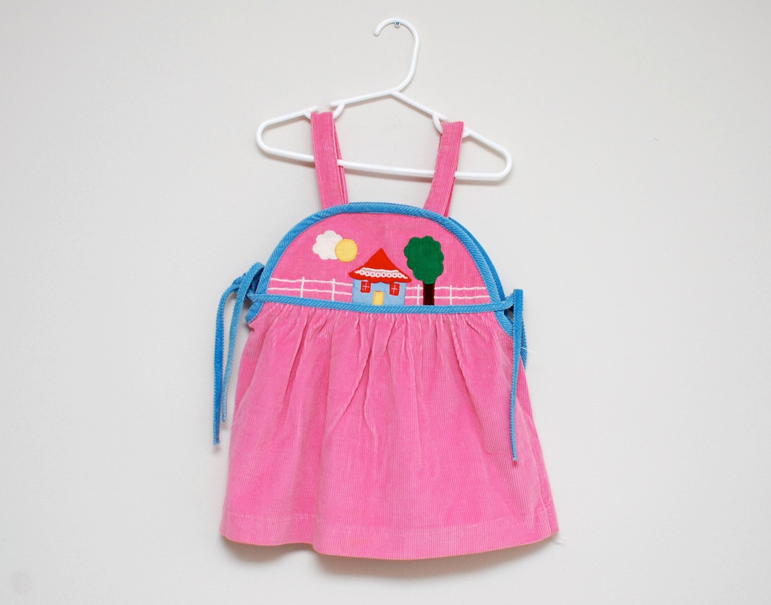 Vintage pink corduroy jumper with house scene applique