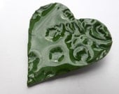 Holly Green porcelain heart brooch, impressed with leaves and berries.