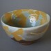 handmade stoneware bowl or chawan or with vibrant yellow ginkgo leaves in Japanese/Craftsman style