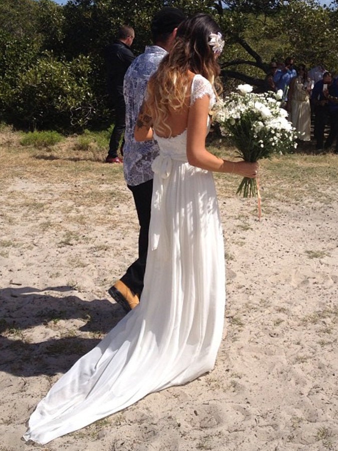 Capped sleeves, low scooped back with rosette trim and train. French lace and silk chiffon wedding dress
