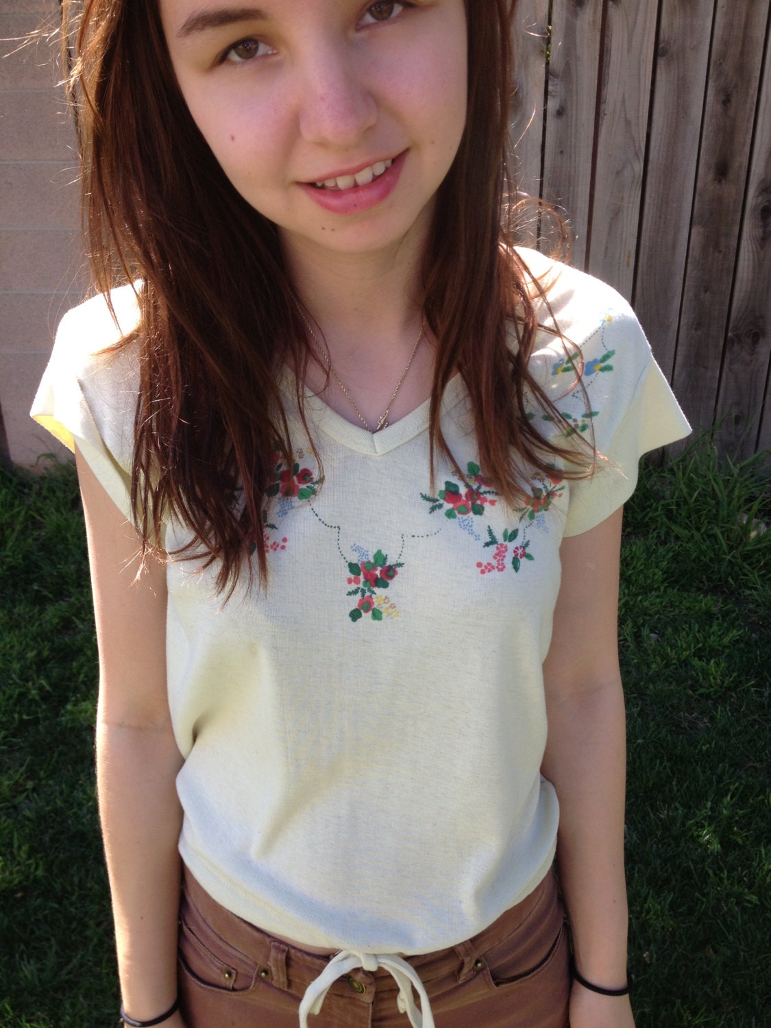 soft yellow shirt with flower detail