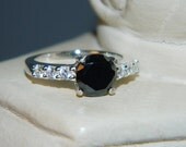 Black diamond ring with accent stones