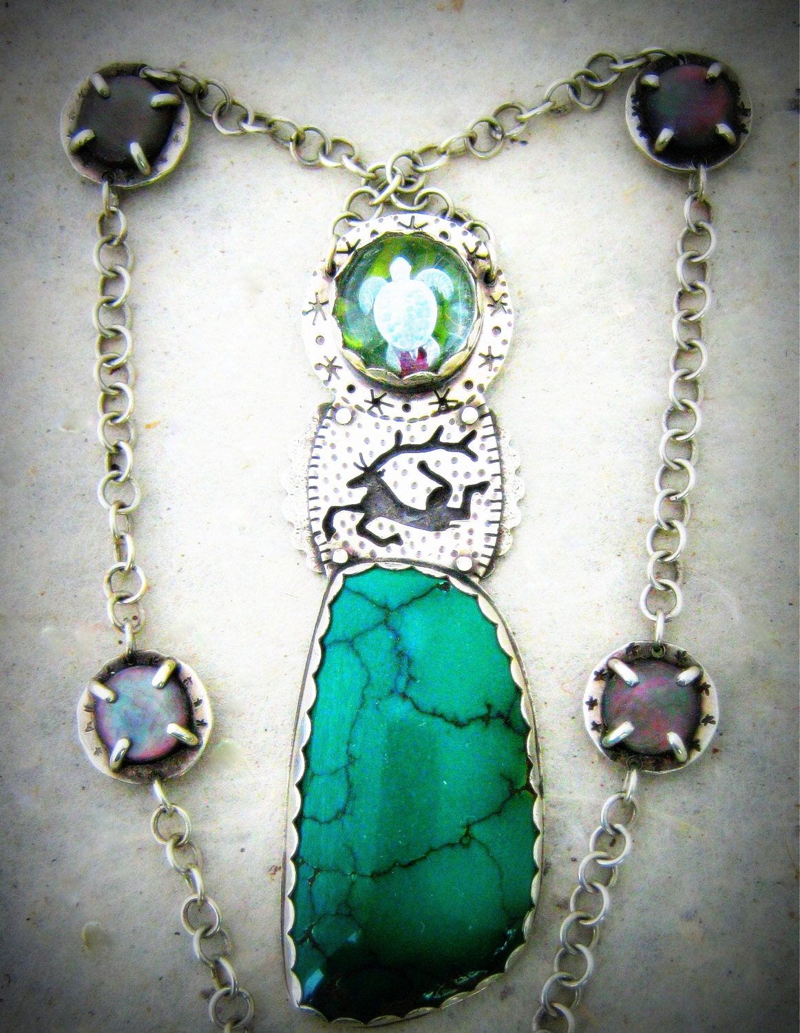 Silver Necklace with Carved Turtle Crystal over Peridot and Ruby, Pierced Scythian Deer and Turquoise Stone.