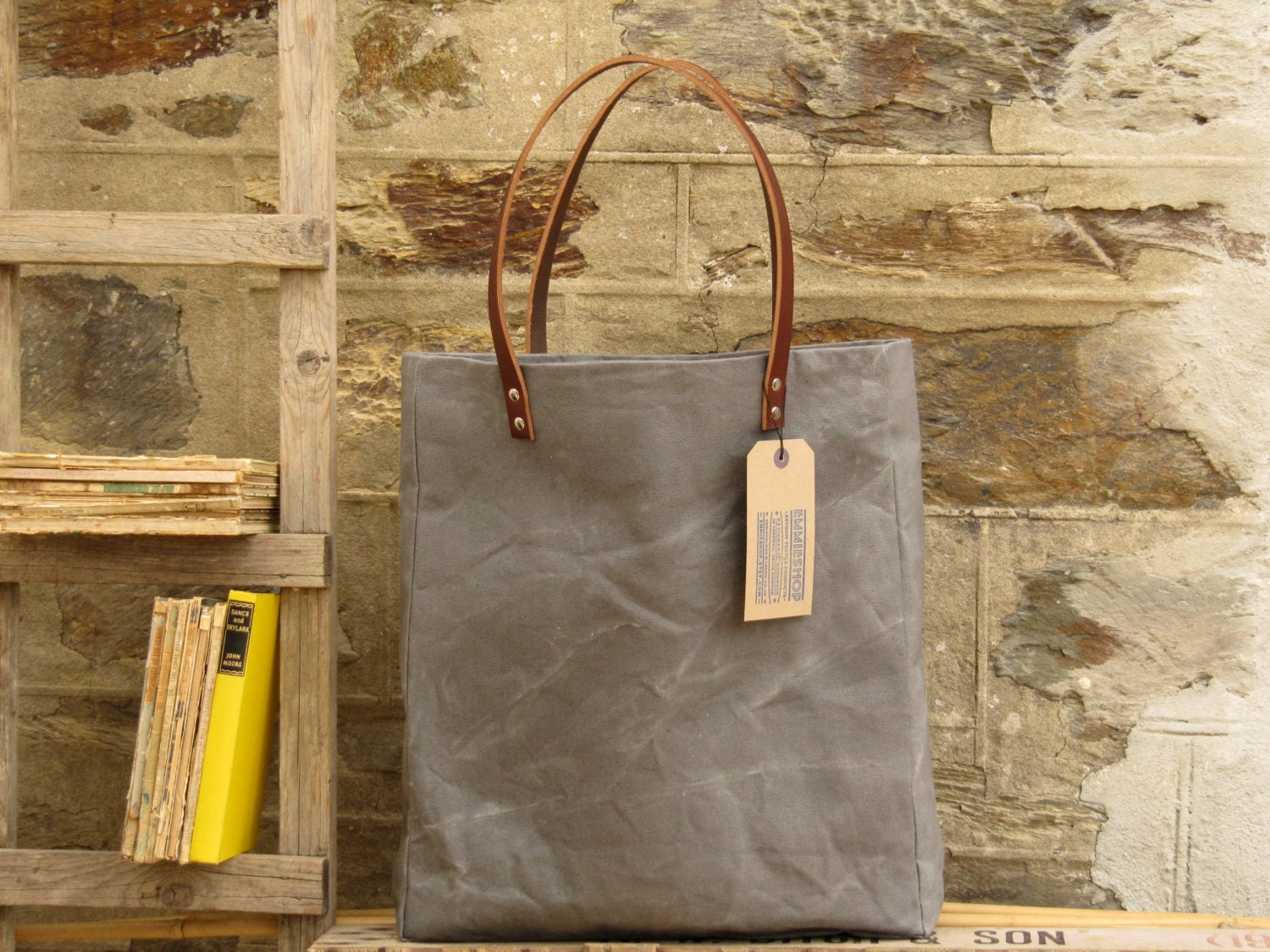 Oversized tote. Thick leather straps. Washed charcoal grey canvas. Yellow cotton stripe lining.