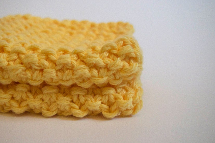 hand knit plushy cotton washcloth in bright canary yellow