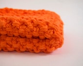 hand knit plushy cotton washcloth in bright neon orange