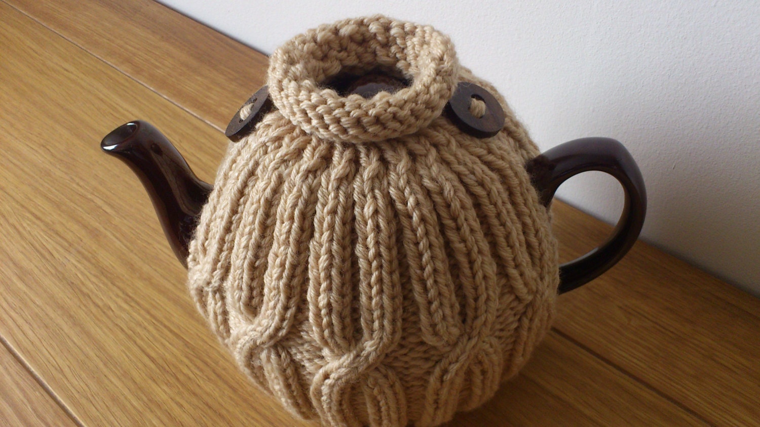 Oatmeal hand knitted tea cosy with wooden button detail