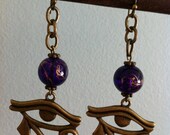 Eye Of Horus Earrings - Antique Bronze Eye Of Ra Charm with Gold Threaded Amethyst Glass Bead Egyptian Jewelry.