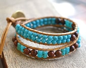 Twice folded beaded bracelet with beige-gold leather cord, turquoise and brown semi precious stones and a bronze button for clasp
