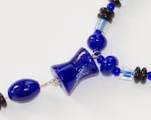 Blue Hourglass: Glass beaded necklace with hourglass-shaped pendant