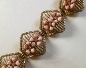 1950s chunky bracelet aged goldtone metal with pink celluloid flowers centered with rhinestones