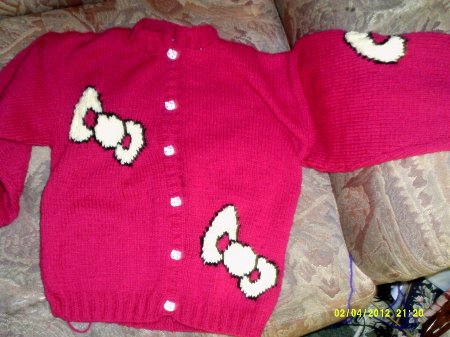 Colourful, hand knitted, cardigan/jacket with hello kitty style design