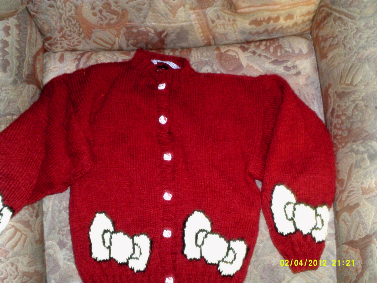 Colourful, hand knitted, cardigan/jacket with hello kitty style design