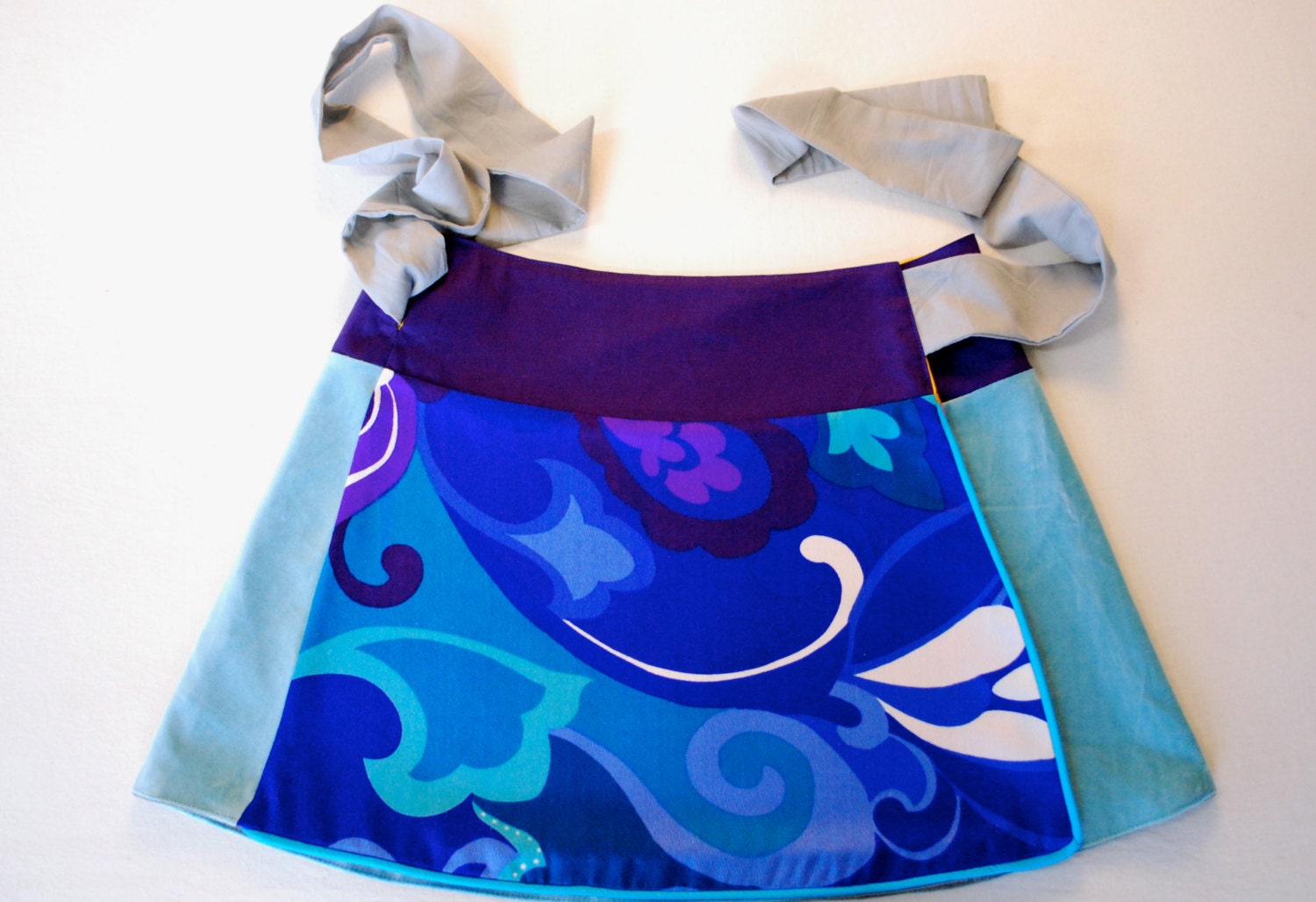 Unique, reversible wrap around mini skirt, a-line shape, turquoise, purple floral on one side, red, tangerine, grey on other side