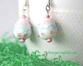 Lampwork Glass Easter Egg Earrings Eggshell White with Blue and Pink. Dangle, hook style earrings. on Hypoallergenic surgical steel.