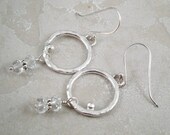 Orbit earrings. Sterling silver, round hoops with silver pebble.  Faceted rock crystal dangle. Free shipping to US.