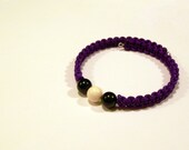 Black and white Swarovski pearl bracelet with dark purple braided rope on adjustable memory wire