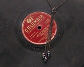 simple three strand front toggle clasp necklace with colorful faceted glass beads and gunmetal toned chain