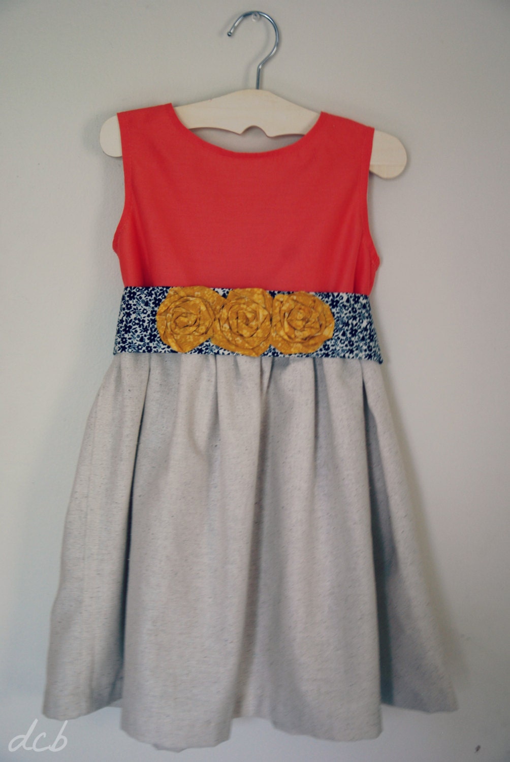 Coral cotton dress with mustard and navy sash