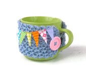 Knitted mug cozy pastel blue mug hug cosie Spring bunting with large painted wooden button