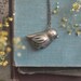 golden bird necklace.