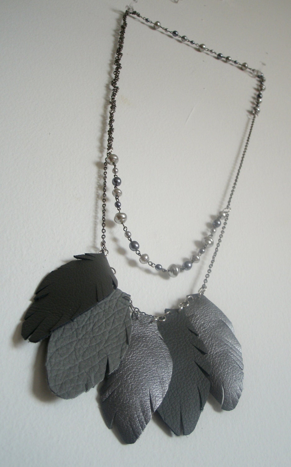 Long pearl and feather necklace made from salvaged leather and upcycled pearl necklace. handmade, one of a kind jewelry