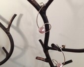 Sterling Silver and Pink Freshwater Pearl Earrings Dangling from a Spiral