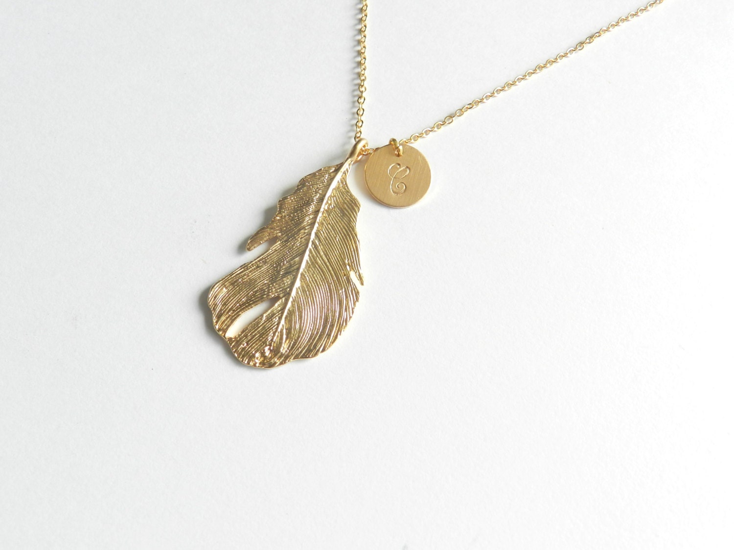 Gold Feather and handstamped charm necklace.
