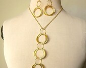 Earrings and necklace jewelry set with large dangling interconnected rings, modern, statement earrings, gold plated