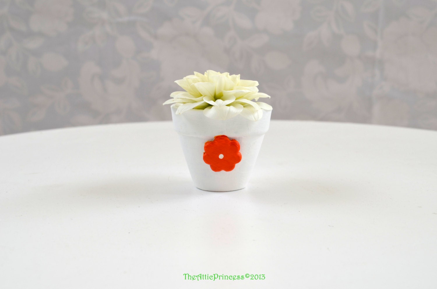 Miniature white planter with orange flower, spring summer home decoration