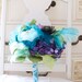 Purple and Aqua fabric and paper flowers paired with Greens and feathers for a stunning wedding bouquet