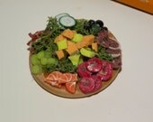 Scale dollhouse miniature meat and cheese party tray made from polymer clay.