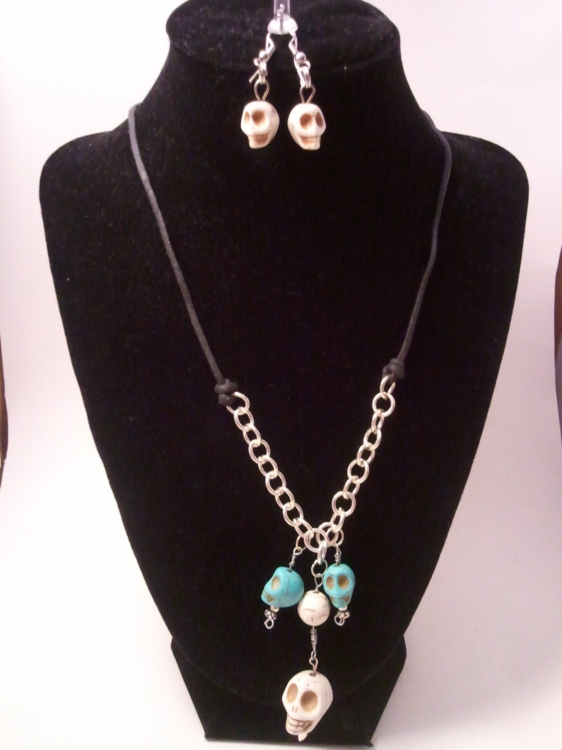 White and Turquoise Dyed Howlite Skull Pendant with Silver and Black Leather Chain Necklace.  Matching Howlite Skull earrings.