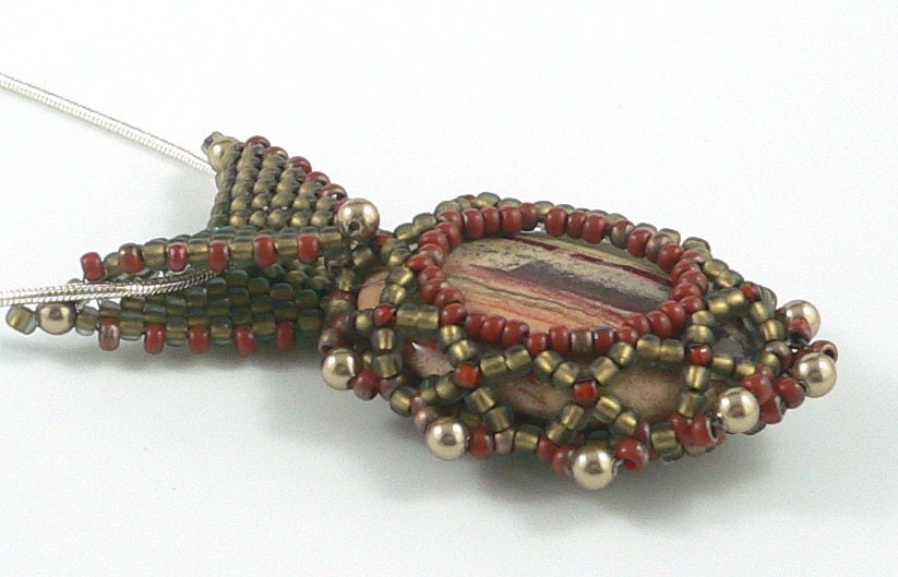 Oval jasper gemstone pendant with beadwork bail