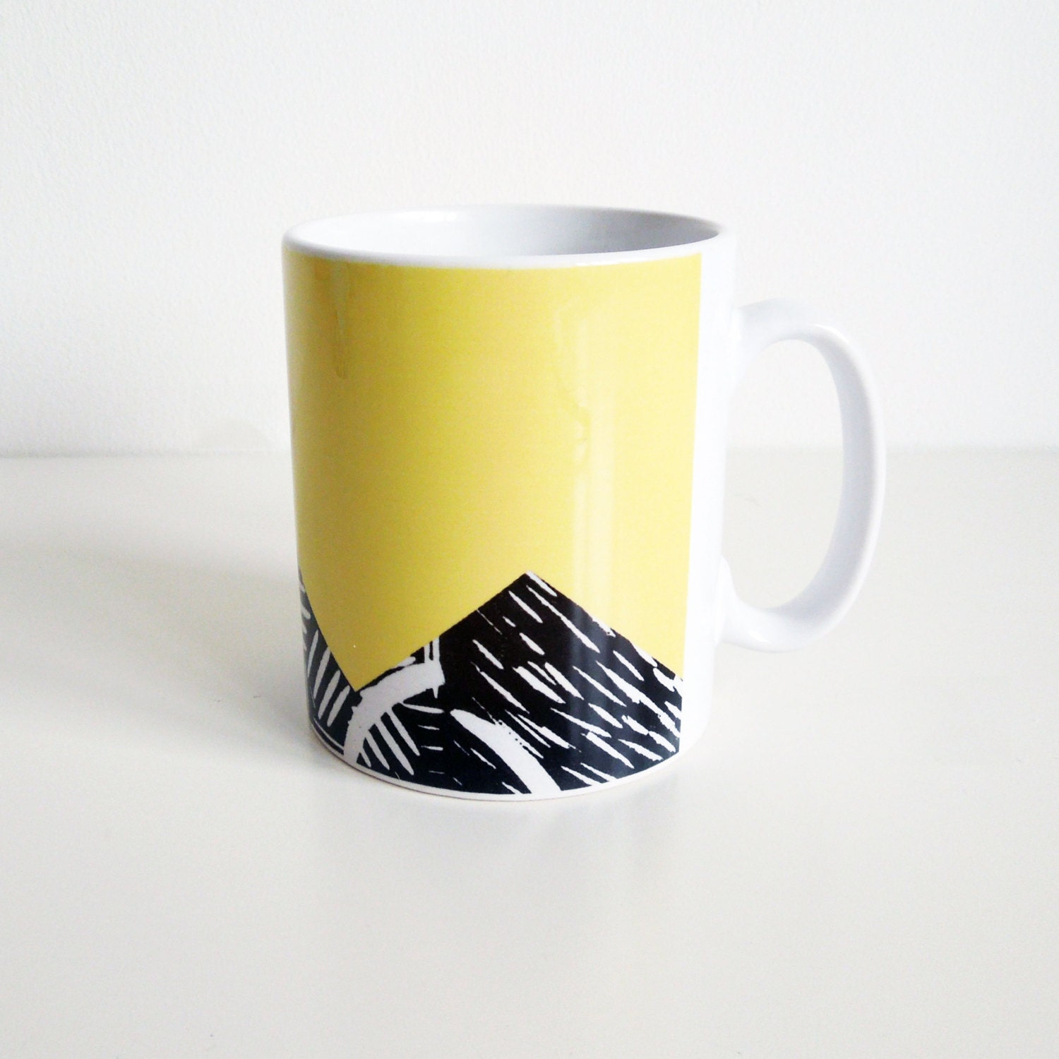 Bright yellow mug with lino print design